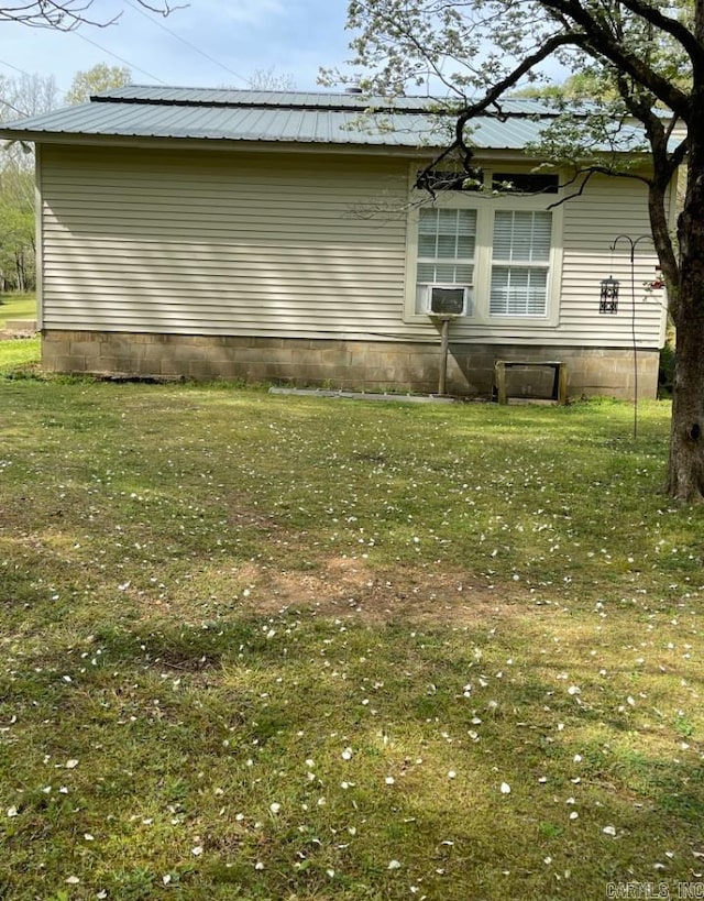 back of house with a lawn