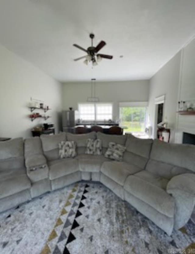 living room featuring light colored carpet and ceiling fan