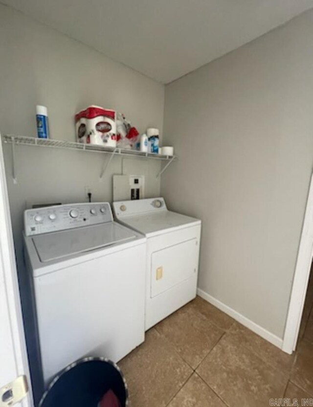 clothes washing area featuring independent washer and dryer and light tile floors