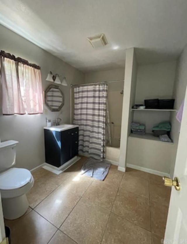 full bathroom with shower / tub combo, toilet, tile floors, and vanity