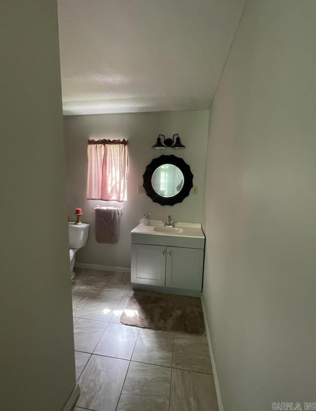 bathroom featuring tile floors, oversized vanity, and toilet