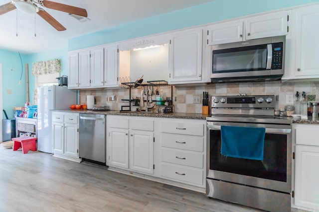 kitchen featuring light hardwood / wood-style floors, backsplash, and stainless steel appliances