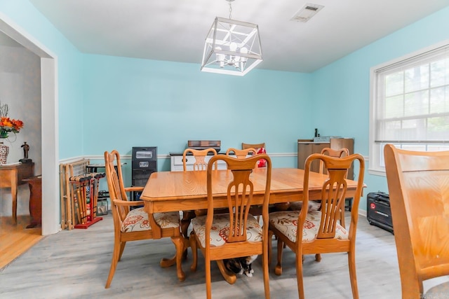 dining room featuring an inviting chandelier and light hardwood / wood-style flooring