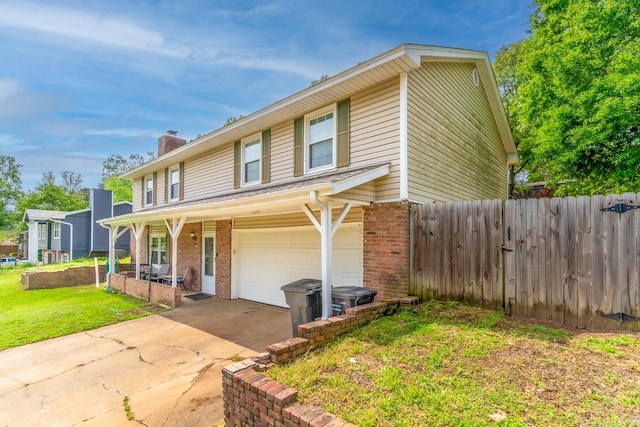 view of property featuring a garage and a front yard