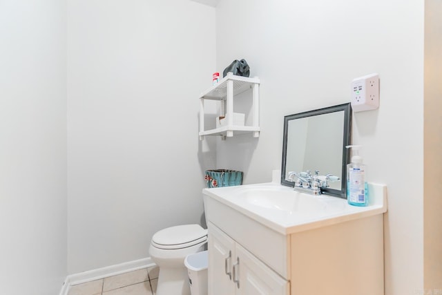 bathroom featuring tile floors, vanity, and toilet