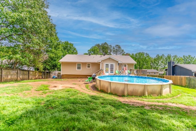 view of pool with a lawn