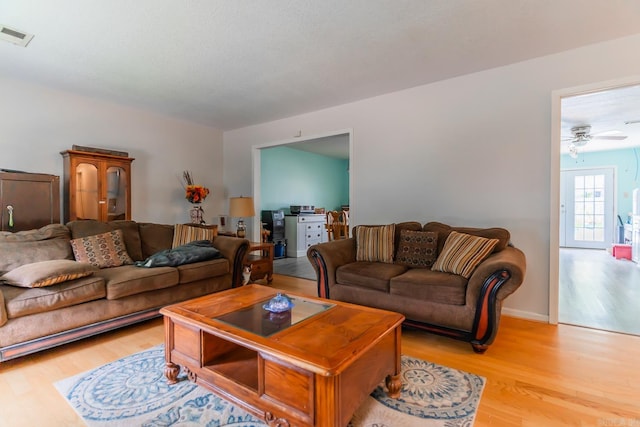 living room featuring ceiling fan and light wood-type flooring