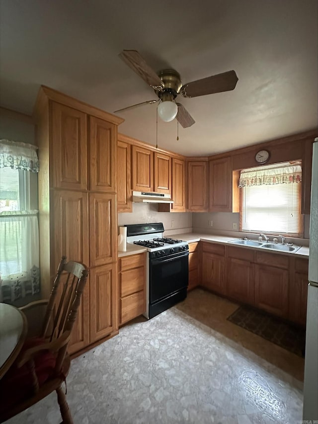 kitchen with ceiling fan, black range with gas stovetop, and sink