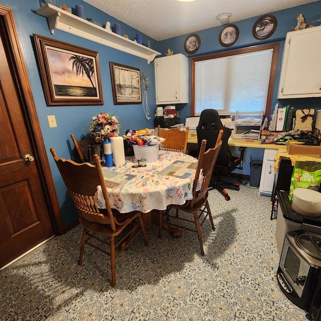 dining room with light tile floors and a textured ceiling