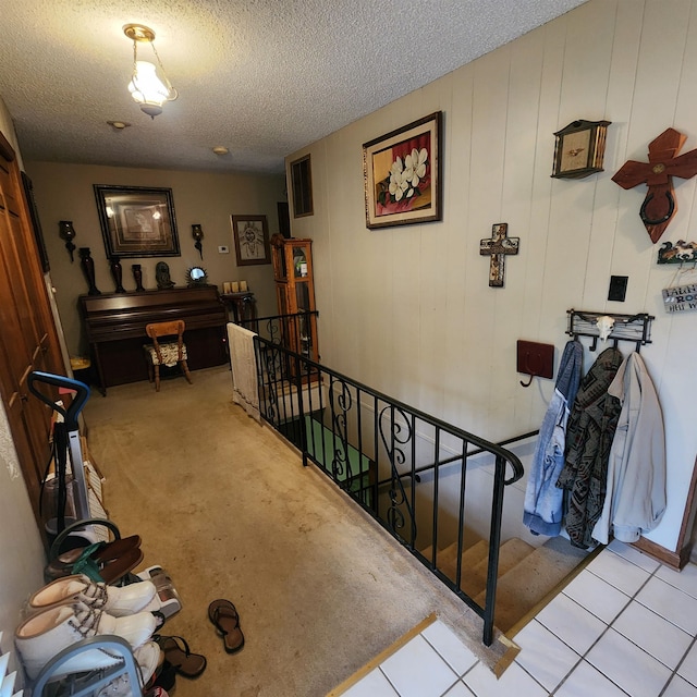 interior space with light colored carpet and a textured ceiling