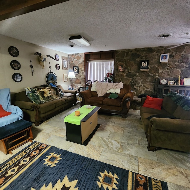 tiled living room featuring a textured ceiling