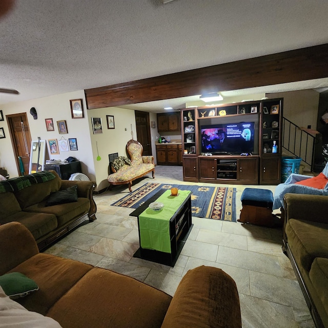 living room with beam ceiling, light tile flooring, and a textured ceiling