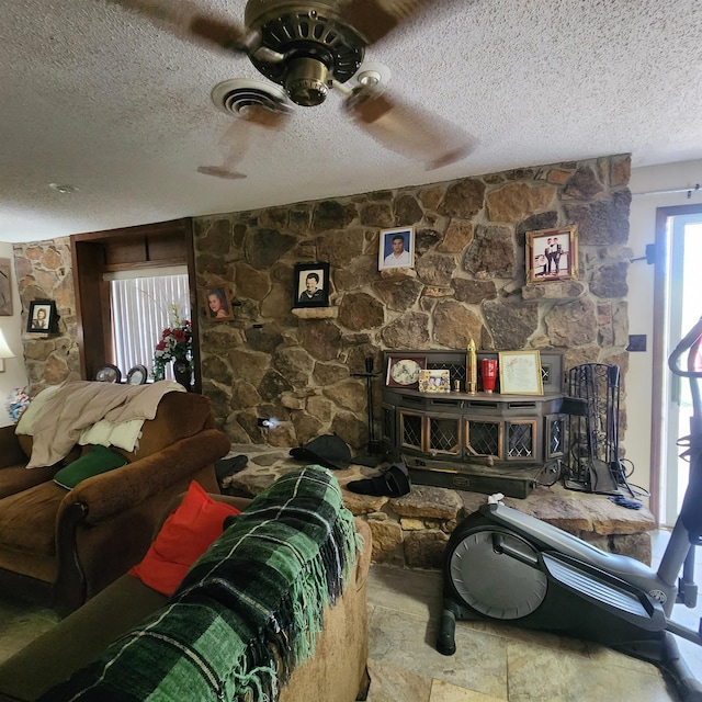 living room featuring a textured ceiling and ceiling fan