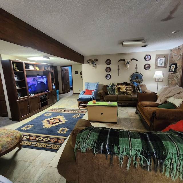 living room featuring light hardwood / wood-style floors, beam ceiling, and a textured ceiling