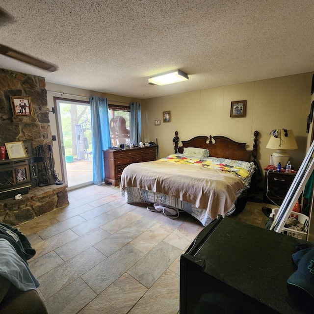 bedroom featuring a textured ceiling and access to exterior