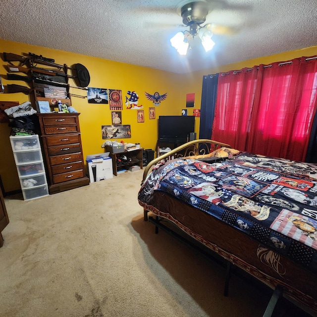 bedroom with a textured ceiling, ceiling fan, and carpet