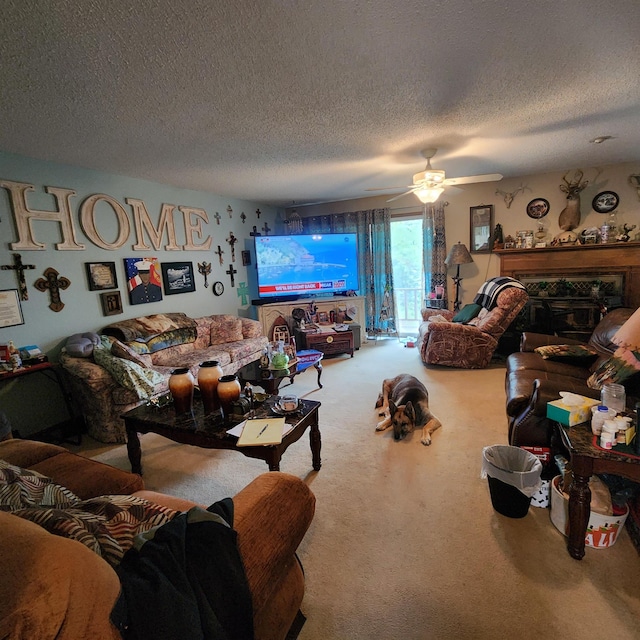 living room featuring light colored carpet, ceiling fan, and a textured ceiling