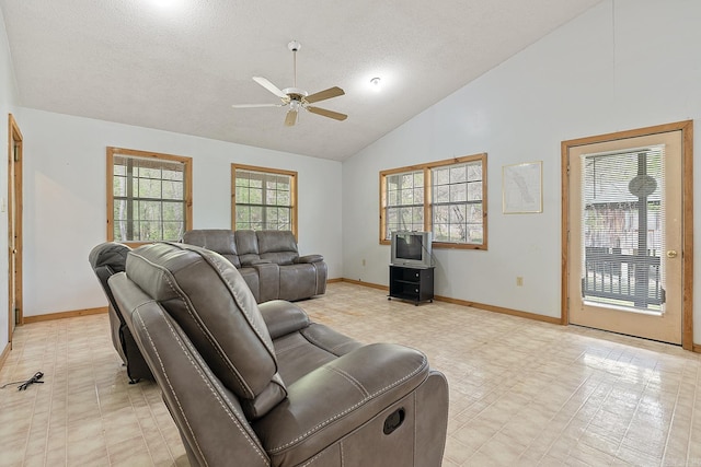 tiled living room featuring high vaulted ceiling, ceiling fan, and a textured ceiling