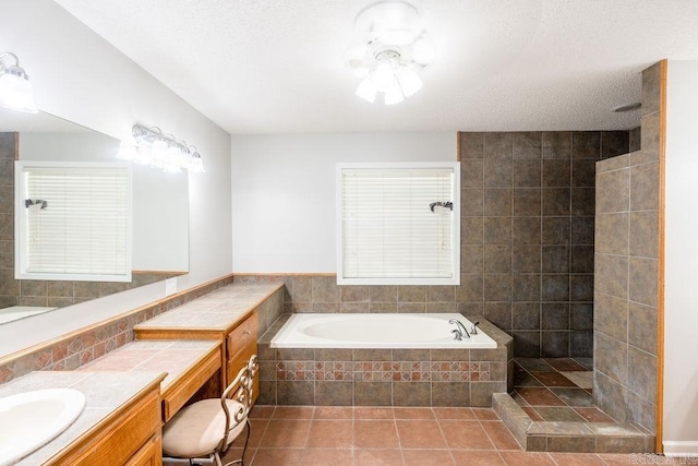 bathroom featuring tile walls, ceiling fan, vanity with extensive cabinet space, tile flooring, and plus walk in shower