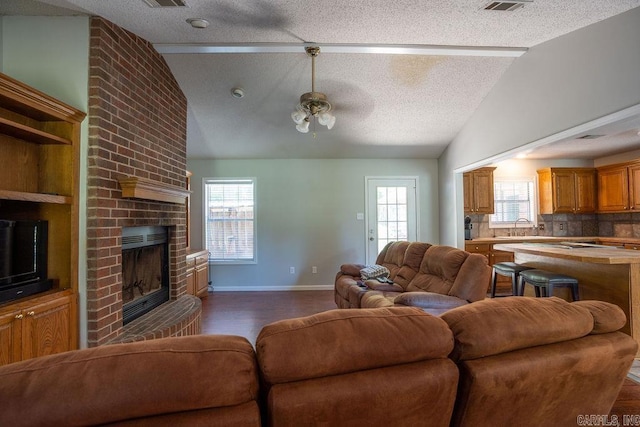 living room featuring a textured ceiling and vaulted ceiling