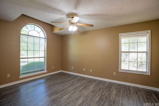 empty room with a textured ceiling, ceiling fan, and dark wood-type flooring