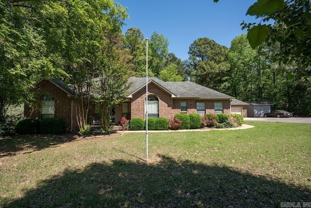 ranch-style home featuring a garage and a front yard