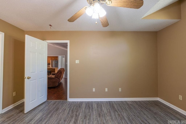 unfurnished room with dark hardwood / wood-style flooring, ceiling fan, and a textured ceiling