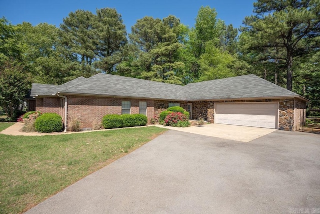 single story home with a garage and a front lawn