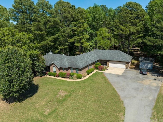 view of front of property featuring a garage and a front lawn