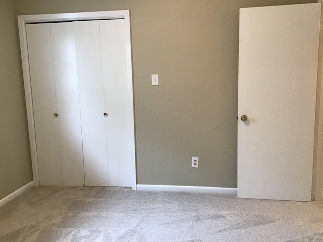 unfurnished bedroom featuring a closet and carpet