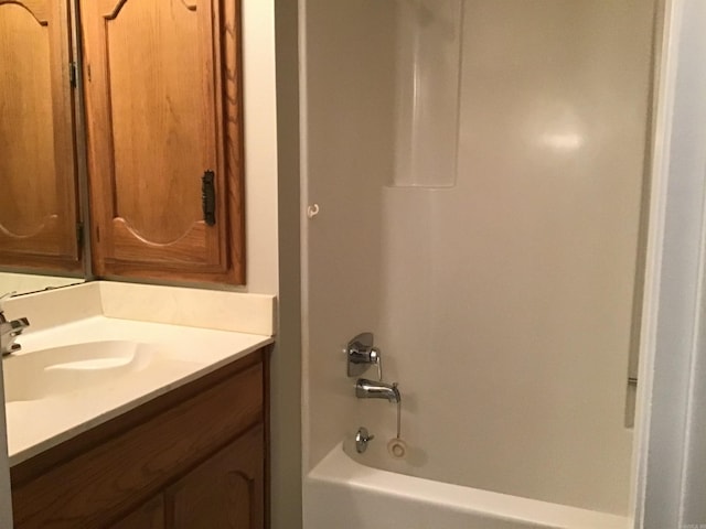 bathroom featuring vanity and  shower combination