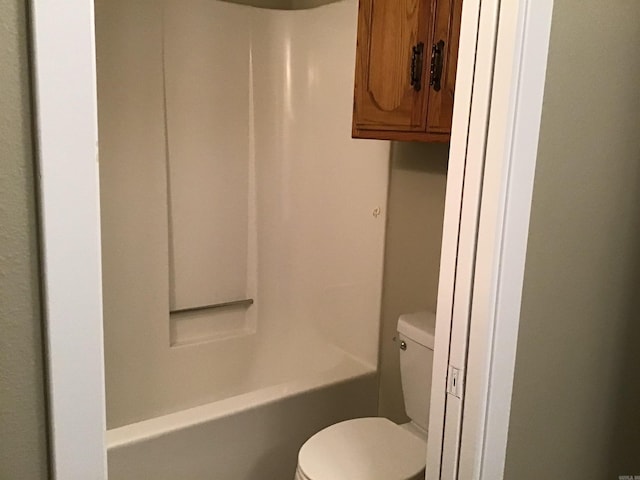 bathroom featuring tub / shower combination and toilet