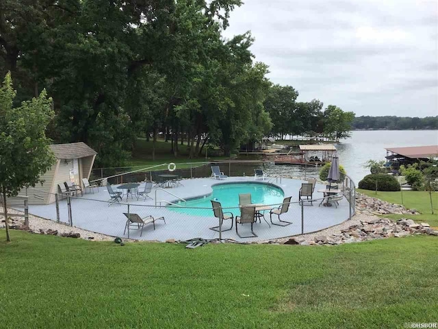 view of pool featuring a patio area, a yard, and an outdoor structure