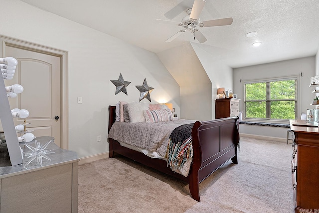 carpeted bedroom with ceiling fan, a textured ceiling, and lofted ceiling