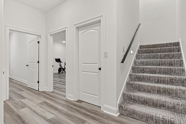 staircase with light hardwood / wood-style floors