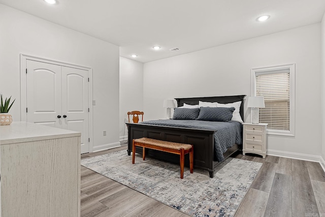 bedroom with a closet and hardwood / wood-style floors