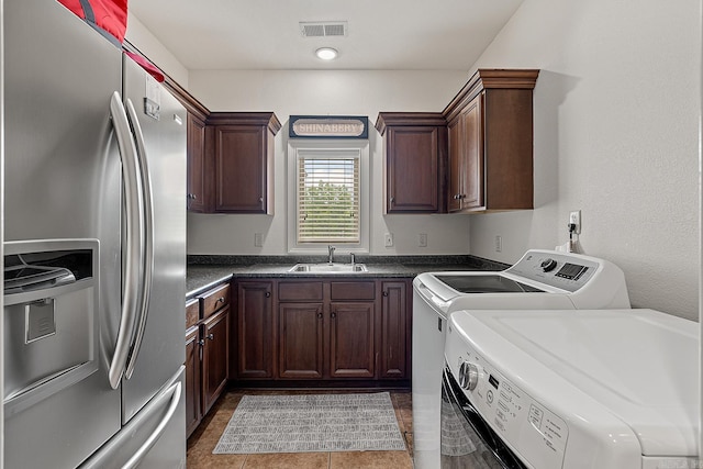 washroom featuring sink, tile floors, and washer and clothes dryer