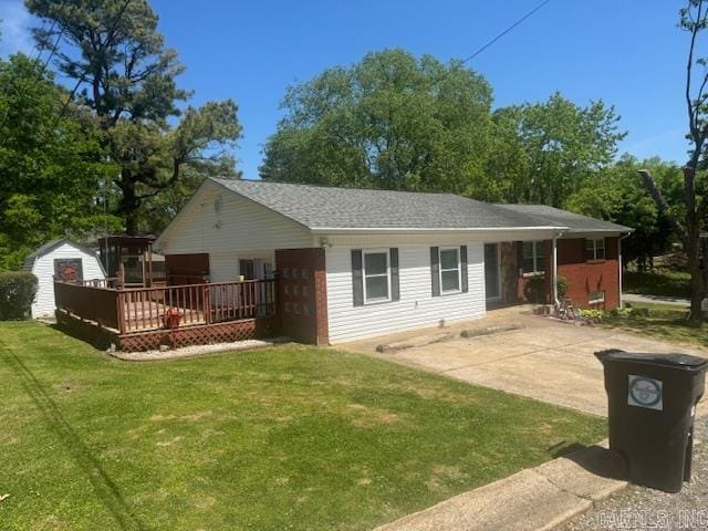 rear view of property with a wooden deck and a yard