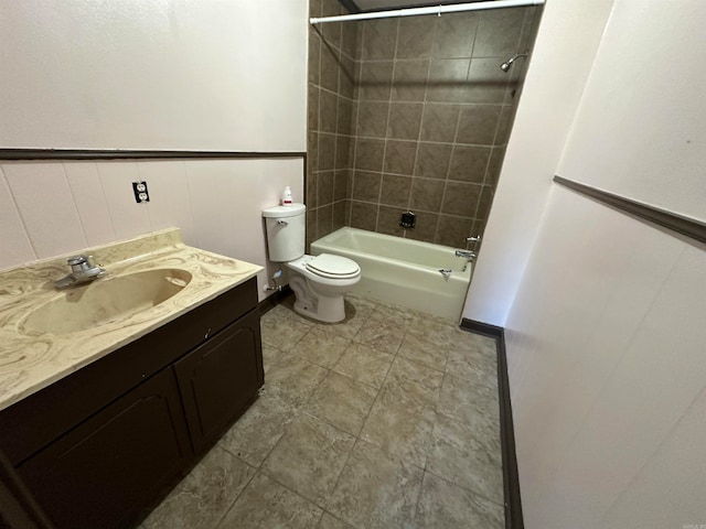 full bathroom with tile flooring, vanity, tiled shower / bath combo, and toilet