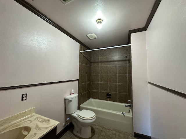 full bathroom with tile floors, toilet, tiled shower / bath, and ornamental molding