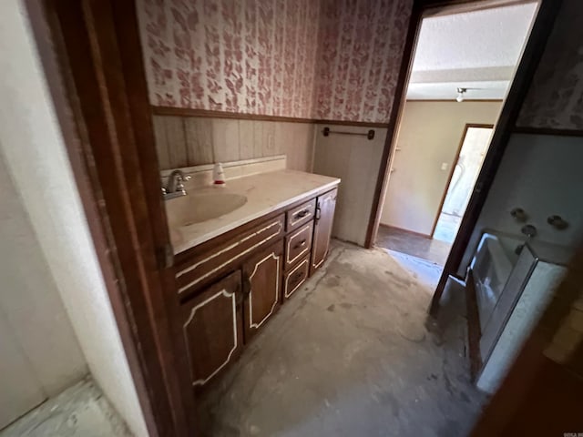 bathroom with concrete flooring and vanity