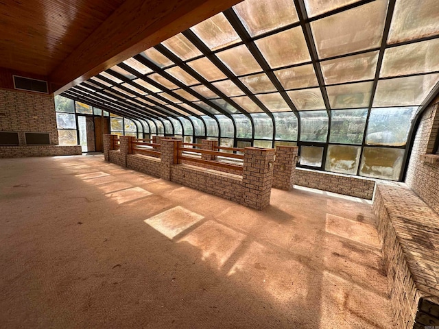 exterior space with lofted ceiling with beams and wooden ceiling