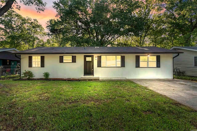 ranch-style house featuring a lawn