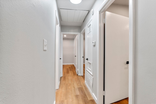 corridor featuring light hardwood / wood-style floors