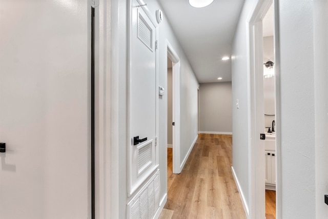 corridor featuring light hardwood / wood-style floors