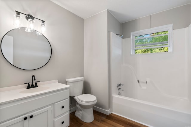 full bathroom with hardwood / wood-style flooring, toilet, vanity, and  shower combination