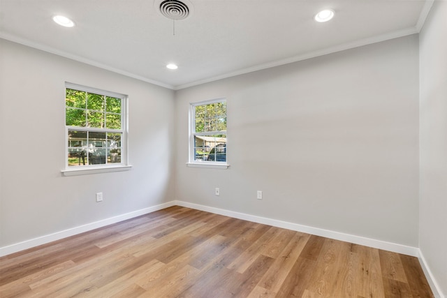 spare room featuring light hardwood / wood-style flooring, plenty of natural light, and ornamental molding