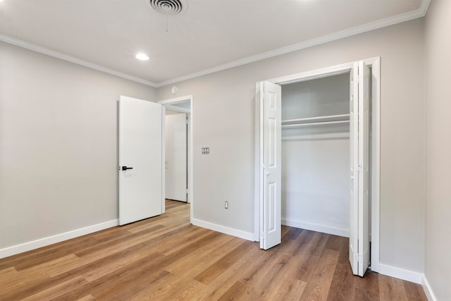 unfurnished bedroom featuring hardwood / wood-style floors, a closet, and ornamental molding