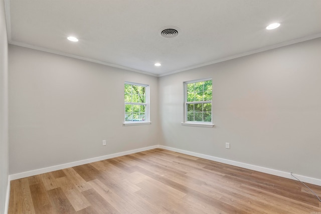 unfurnished room featuring light hardwood / wood-style floors and crown molding