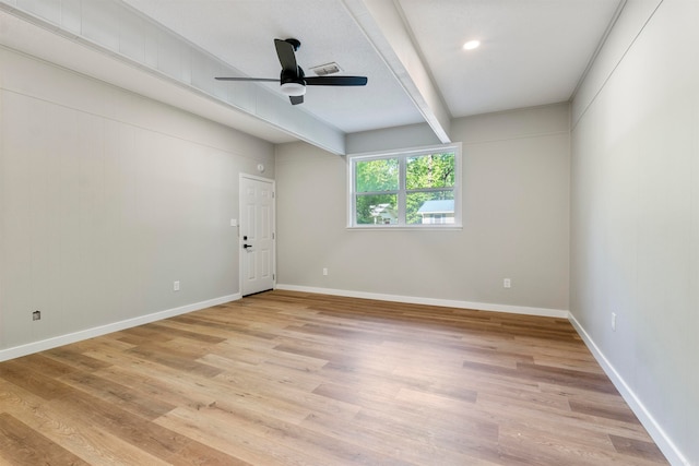 unfurnished room featuring beamed ceiling, light hardwood / wood-style flooring, and ceiling fan